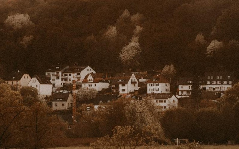 a country farm with several buildings, rolling pastures and gardens