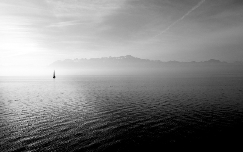 sailboat on a lake going home after a long day